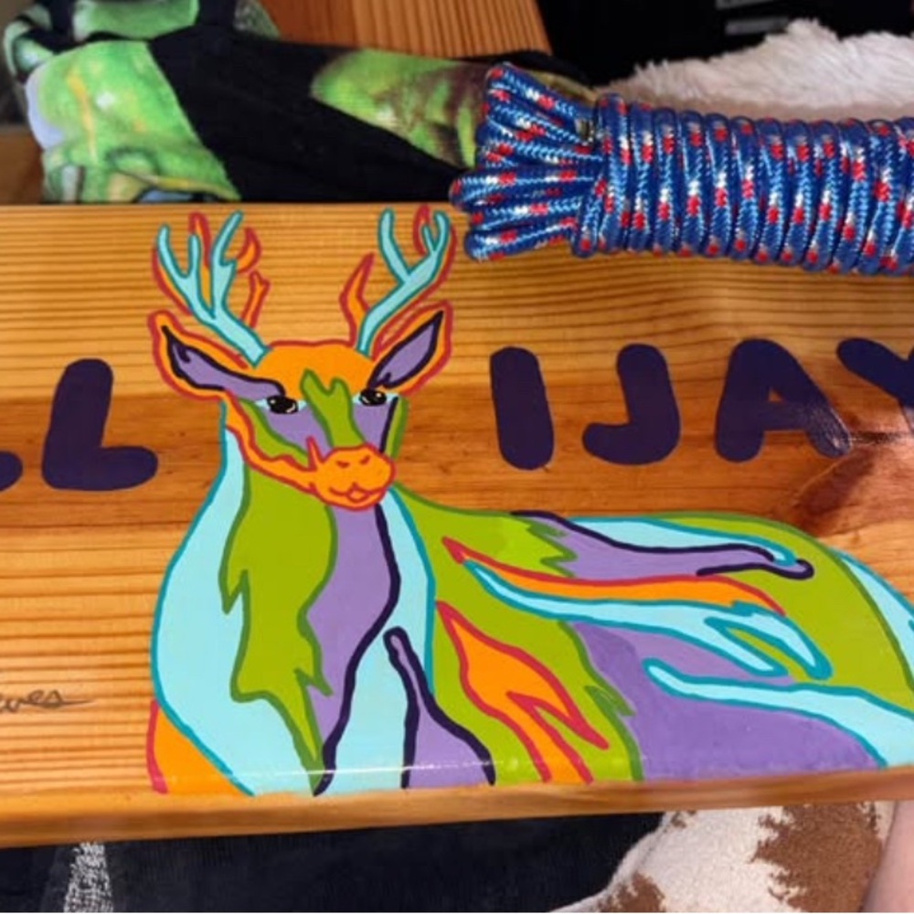 Colorful Deer Art on Wooden Swing
